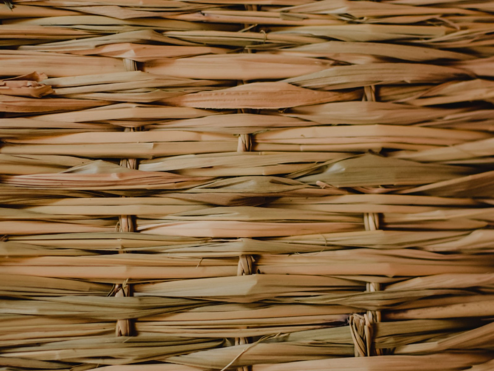 Close-up of dark hand-woven straw craft by a Filipino artisan